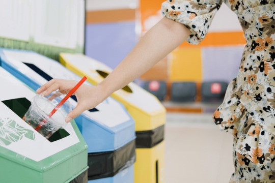 woman-drop-plastic-cup-into-recycling-bins-concept-of-global-environmental-protection-and 540x360